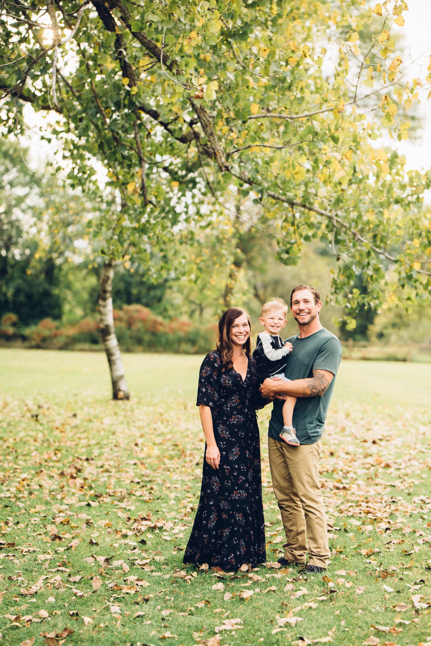 Family of 3 playing during central minnesota family portrait session