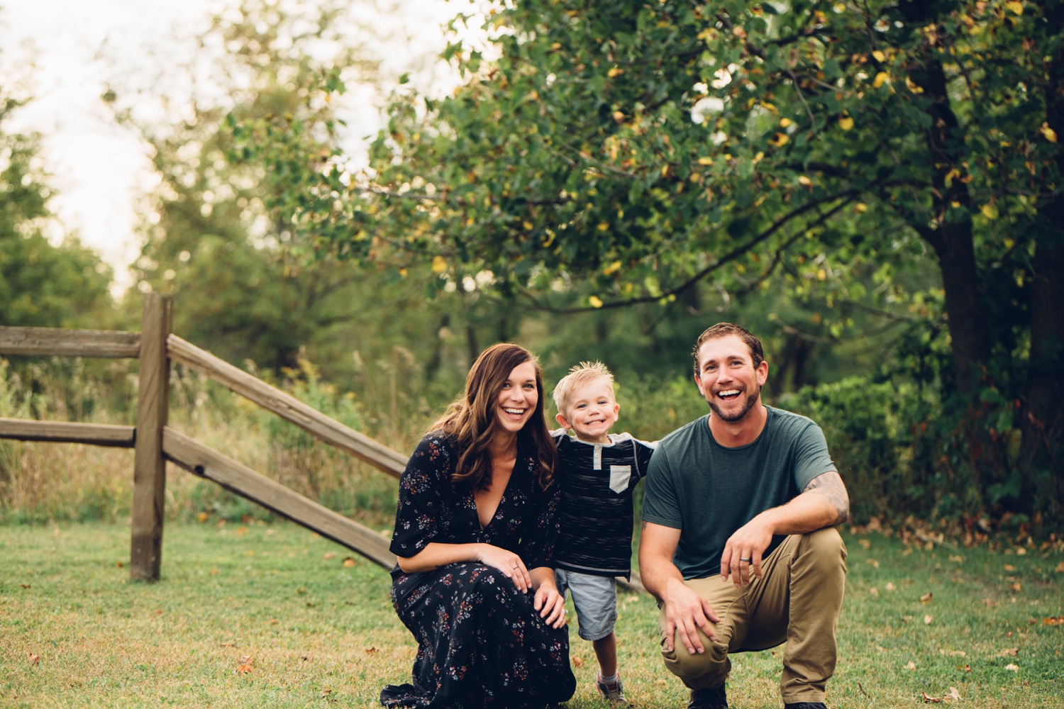 Family of 3 playing during central minnesota family portrait session